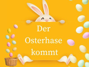 Man sieht einen Osterhasen der ein Schild hält auf dem "Der Osterhase kommt" steht. Daneben befinden sich bunte Ostereier.