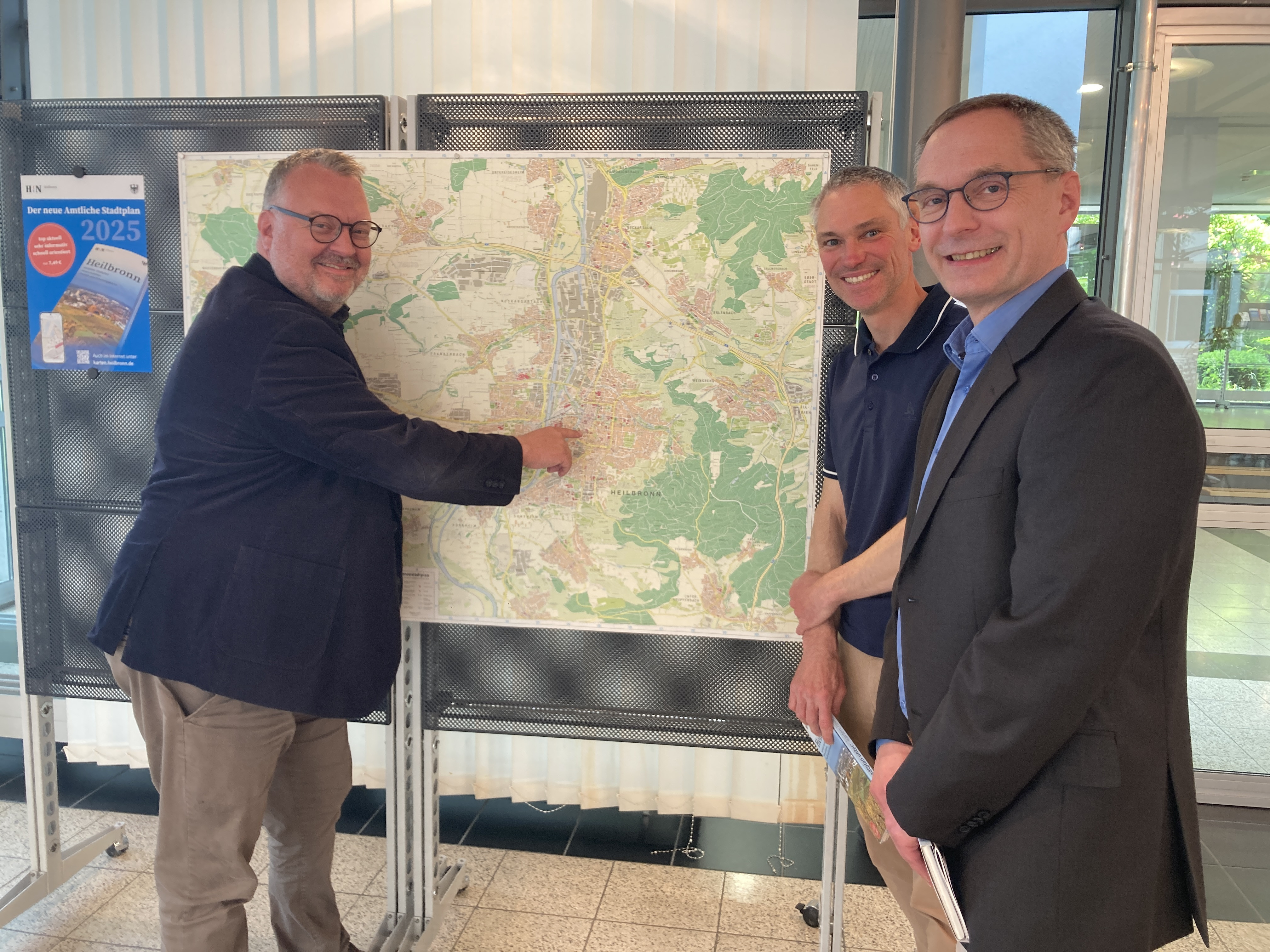 Bürgermeister Andreas Ringle(l.), Stefan Schmitt (r.v.), Leiter des Vermessungs- und Katasteramtes, und sein Stellvertreter Volker Buhl präsentieren den neuen Amtlichen Stadtplan für Heilbronn. Foto: Stadt Heilbronn