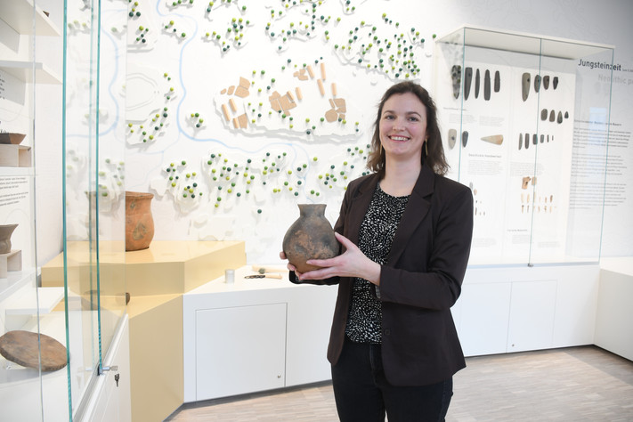 Das Bild zeigt Archäologie-Leiterin Juditz Wötzel mit einem Vorratsgefäß aus der Jungsteinzeit. 