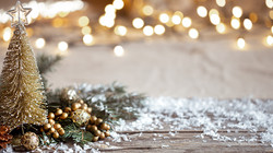 winter-cozy-background-with-festive-decor-details-snow-on-a-wooden-table-and-bokeh-the-concept-of-a-festive-atmosphere-at-home